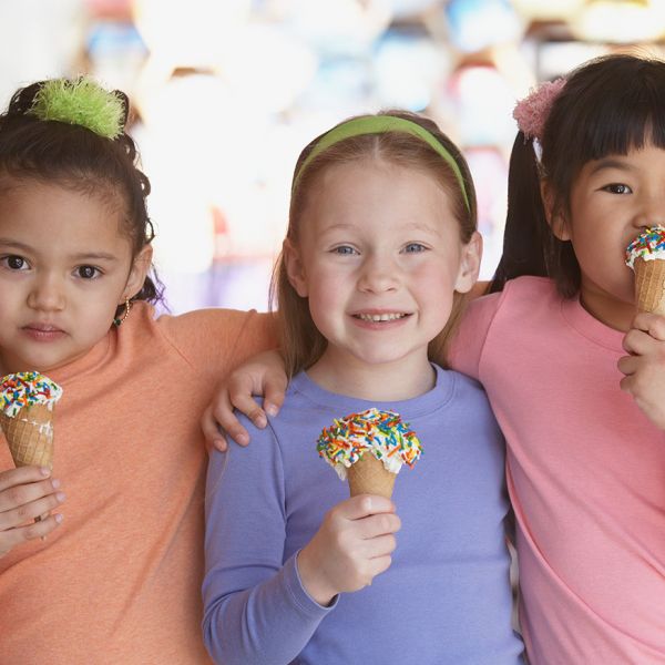 three young girls eating ice cream